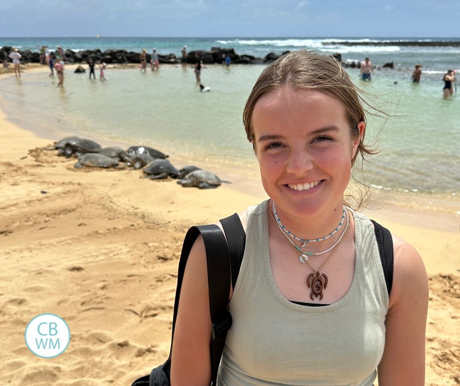 Kaitlyn on Poipu beach with sea turtles in the background